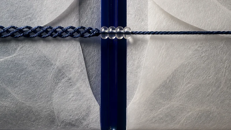 A folded indigo data map crosses a pale border while a small operator checks each handoff.