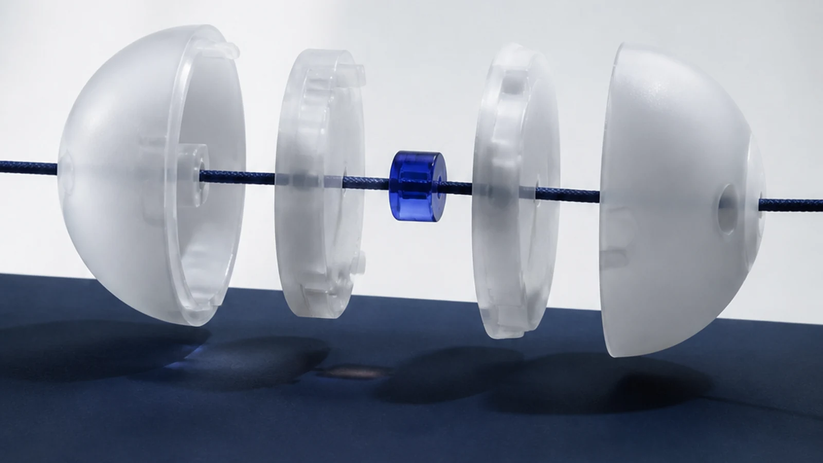 An indigo package unfolds into material, use, sorting, and recovery layers on a pale studio surface.