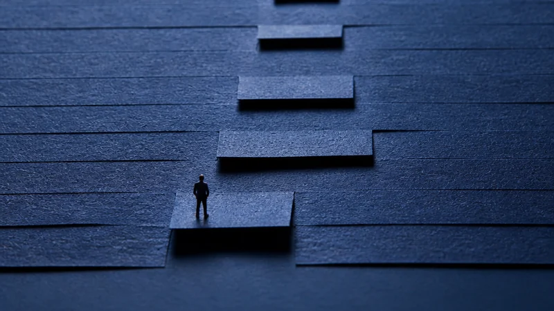 Indigo paper tabs form one raised route toward a small light.