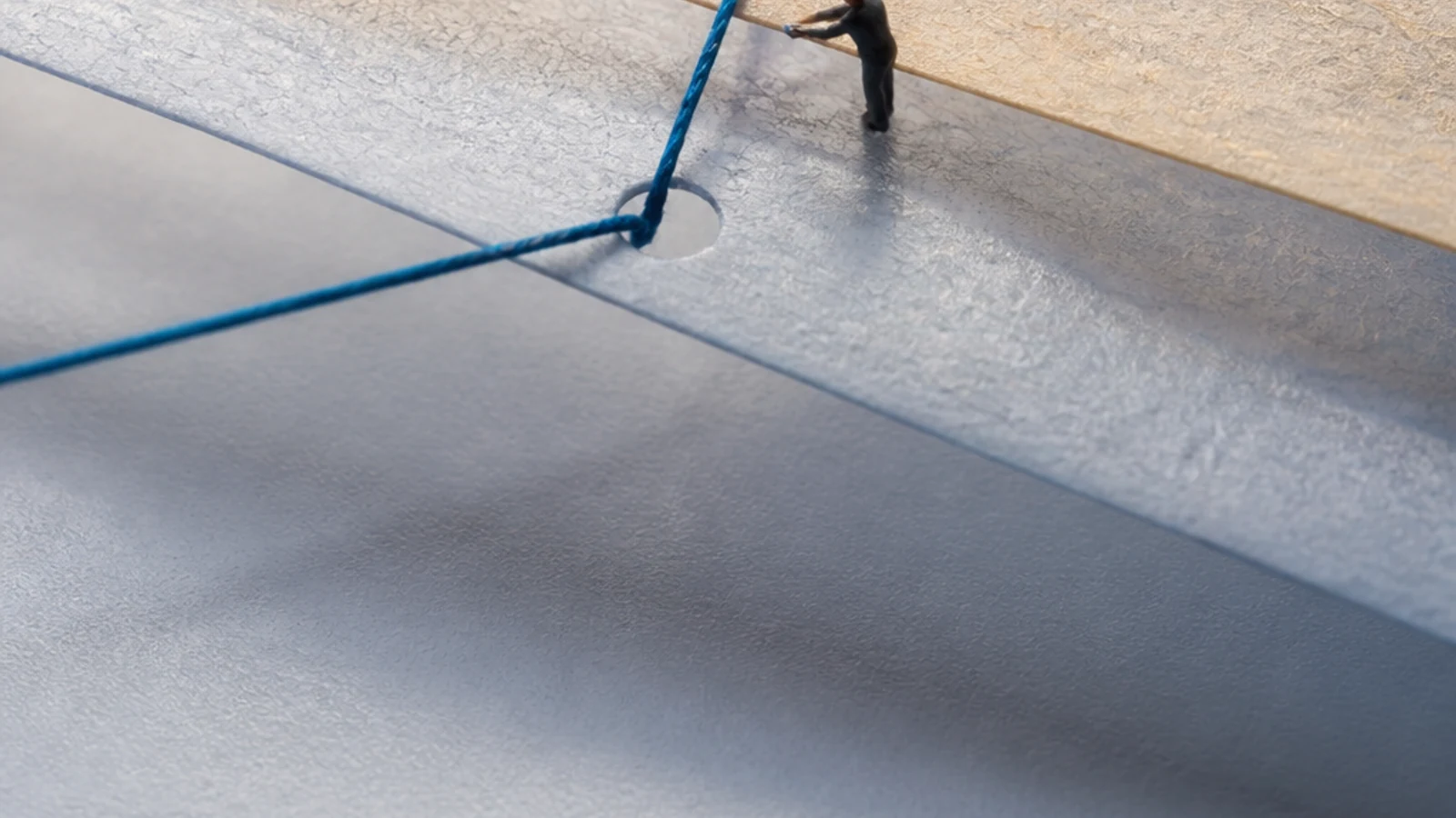 Two translucent sheets align over a single blue thread that continues through both.