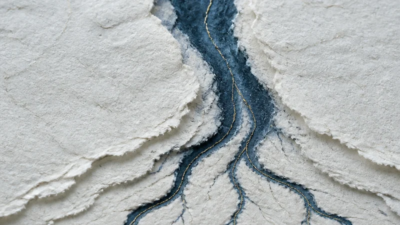 A broad pale paper current becomes one dominant indigo river and several smaller tributaries.